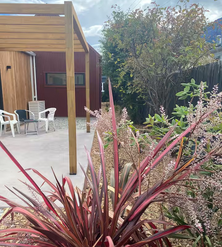 Garden patio with wooden pergola and native planting